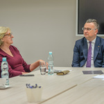 Zastępca Prezydenta i przewodnicząca Białostockiej Rady Seniorów rozmawiają, siedząc przy stole.