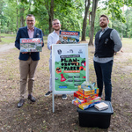 Zastępca prezydenta Białegostoku oraz przedstawiciele organizacji realizującej projekt pozują do zdjęcia z plakatem informacyjnym i grami planszowymi.